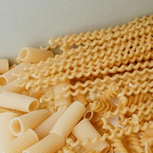Close-up image of assorted uncooked pasta varieties. Perfect for food and culinary content.