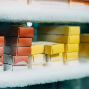 Stacked mochi ice cream boxes in a frost-covered display freezer.