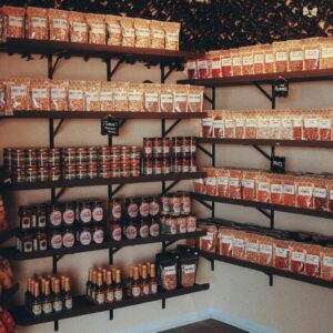Neatly organized pantry showcasing various food items on shelves with warm lighting.